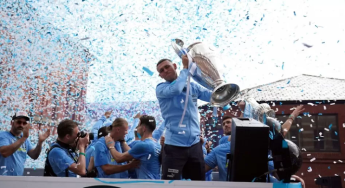 Manchester City fans and players celebrate historic Treble in the rain